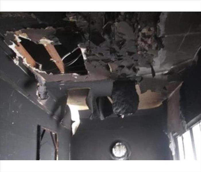 Blackened hanging ceiling material after the fire