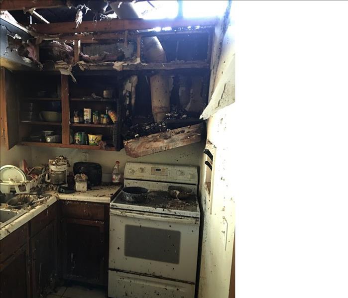 Kitchen area burnt, charred, opening in the roof