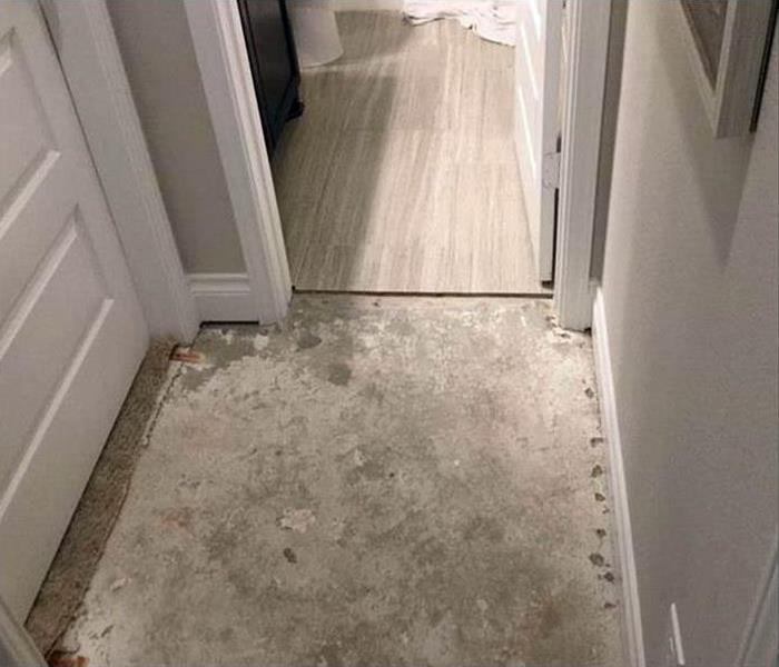 Water damaged flooring outside bathroom