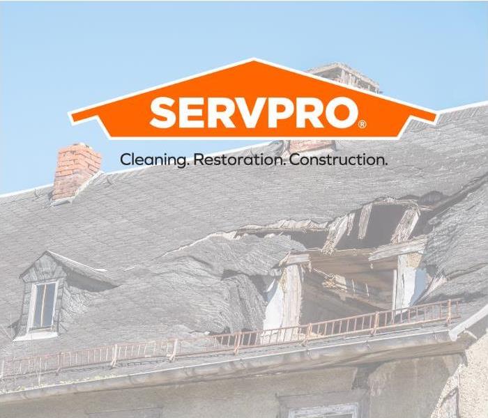 Damaged roof with SERVPRO logo