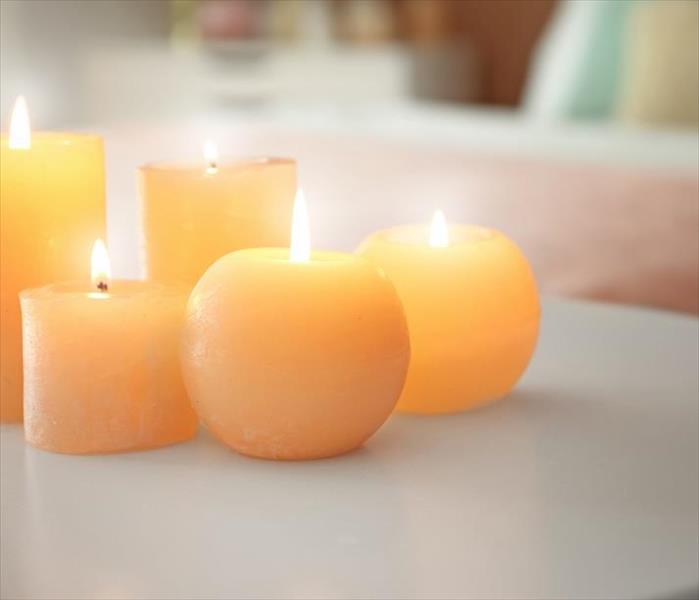 Five small candles burning on table in bedroom