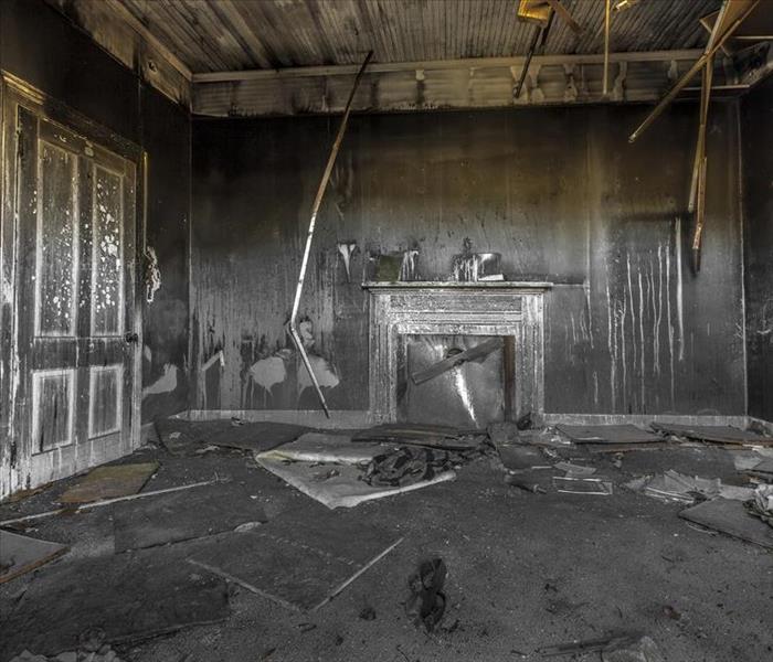 A living room with fire and soot damage. 